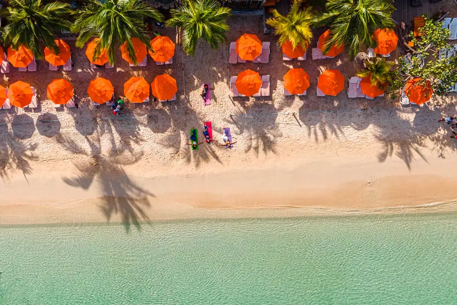 Aerial view of Paradise Beach with orange umbrellas, Roatan