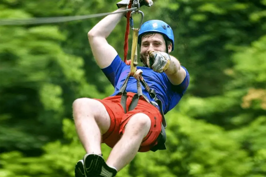 Zip line rider over the jungle canopy in Roatan