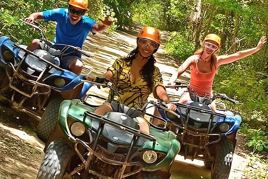 ATV jungle tour riders with helmets in Roatan